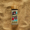Sri Lankan white Pepper powder in a glass jar with ground white pepper in the background — single origin spices from Raksha