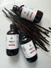 Sri Lankan vanilla extract poured next to whole vanilla beans