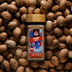 Sri Lankan nutmeg powder in a glass jar with whole nutmeg seeds — single origin spice from Raksha